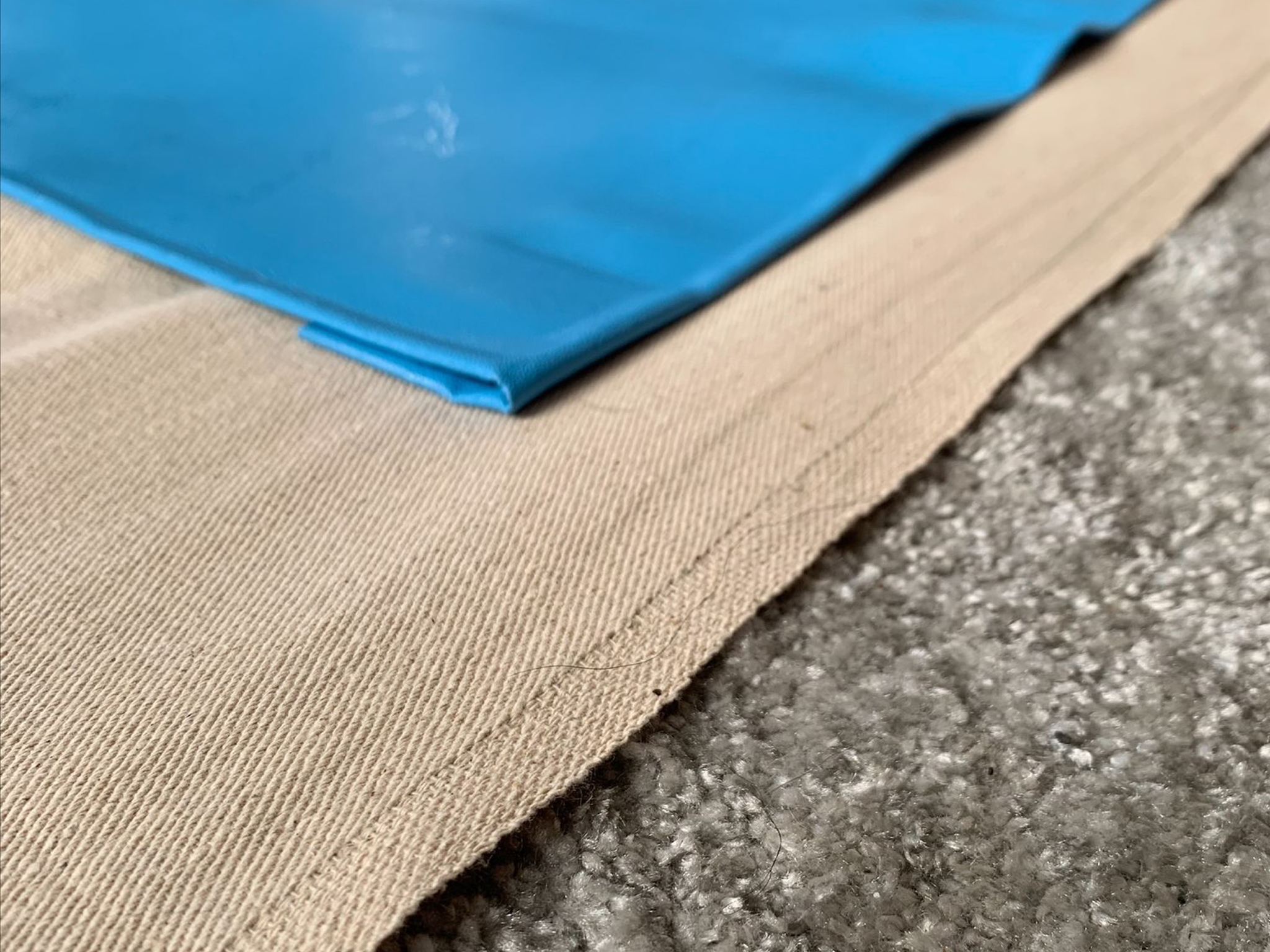 Professional floor protection setup with cotton and plastic sheets